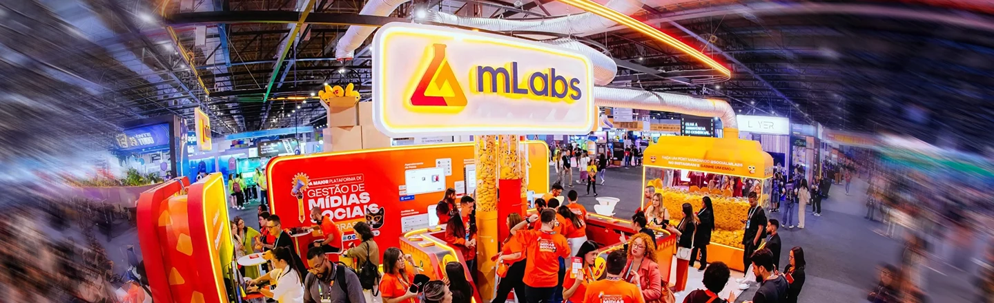Photo of an mLabs booth with mLabs team members and event attendees